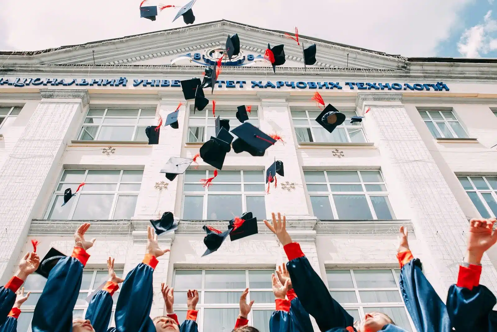 Medicine Universities in Philippines group of fresh graduates students throwing their academic hat in the air